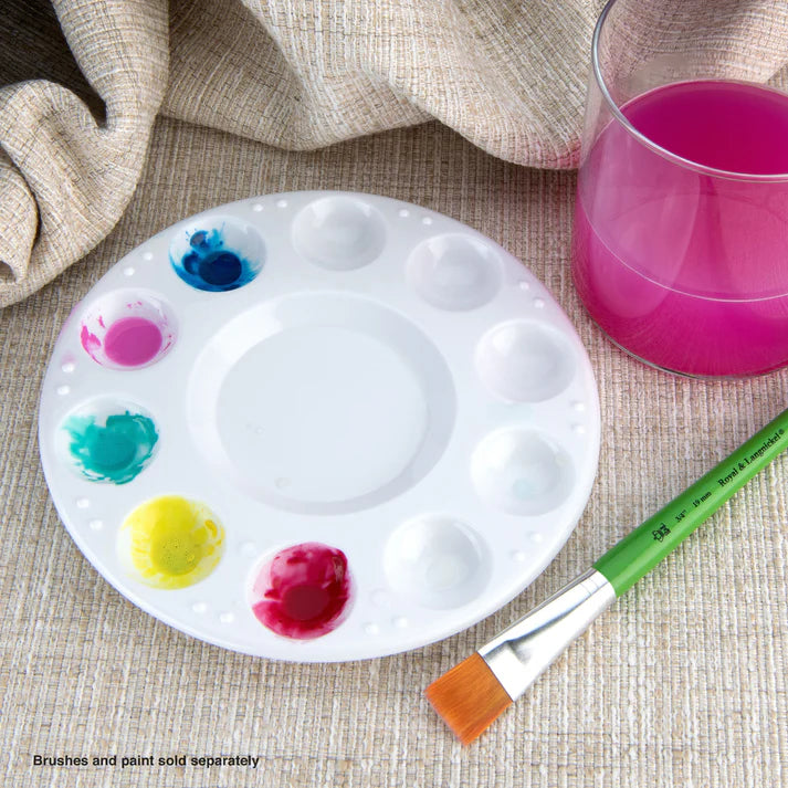 A white plastic paint mixing palette with 10 wells, containing small amounts of different colored paint. A paintbrush and a glass of pink paint are also visible in the image.