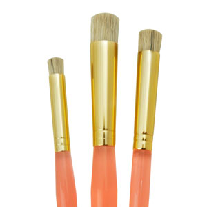A set of three stencil brushes with two-tone handles, gold at the top and orange towards the bottom.