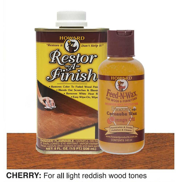 Howard Restor-A-Finish and Feed-N-Wax products on a wooden surface with cherry wood finish.