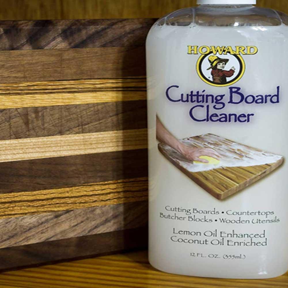 Howard Cutting Board Cleaner bottle with a wooden cutting board in the background