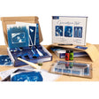 Cyanotype kit with photos and supplies on a wooden surface