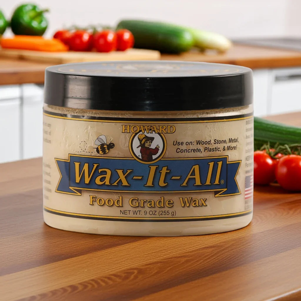 a tub of Howard wax-it-all food grade wax situated on the kitchen worktop with a mixture of vegetables ready for food preparation