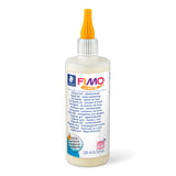 A 200 ml bottle of FIMO Liquid Clay Binder with an orange cap and white label, shown on a clean white background.