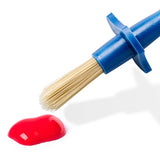Blue brush with a red liquid on a white background