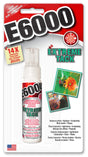 A bottle of E6000 Extreme Tack Craft Glue with a red and white label.