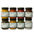 8 jars of Jacquard textile color fabric paints in earth tones on a white background