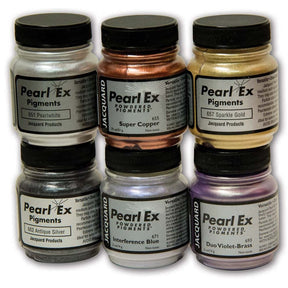 Six jars of Jacquard Pearl Ex Pigments powder arranged in two rows on a white background. The jars show different metallic and shimmer pigment colors: Pearlwhite, Super Copper, Sparkle Gold, Antique Silver, Interference Blue, and Duo Violet-Brass.