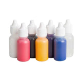 A set of eight small plastic bottles with white dropper-style caps, filled with or showing translucent colors including white, pink, black, orange, purple, and blue, arranged on a plain white background.