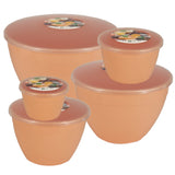 Set of peach-coloured pudding bowls with lids on a white background