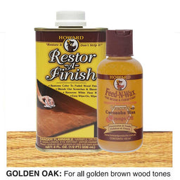 Howard Restor-A-Finish and Feed-N-Wax bottles on a golden oak wooden surface.