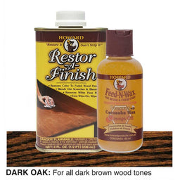 Two bottles of Howard Restor-A-Finish and Feed-N-Wax on a dark oak wooden surface.