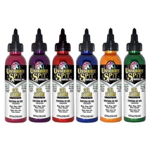 A number of sparkling unicorn spit bottles on a white background