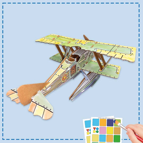 3d cardboard seaplane model being painted by a child