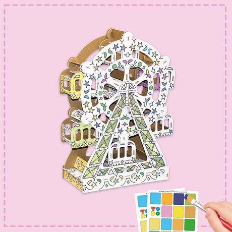 Colorful Ferris wheel craft kit with color swatch on a pink background