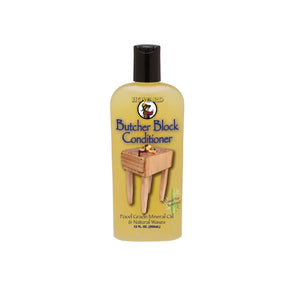 Butcher block conditioner bottle with a wooden block on a white background