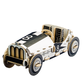 Model of a vintage race car with checkered pattern on a white background