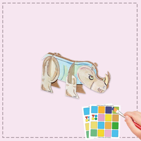 3d carboard rhino being painted by a child