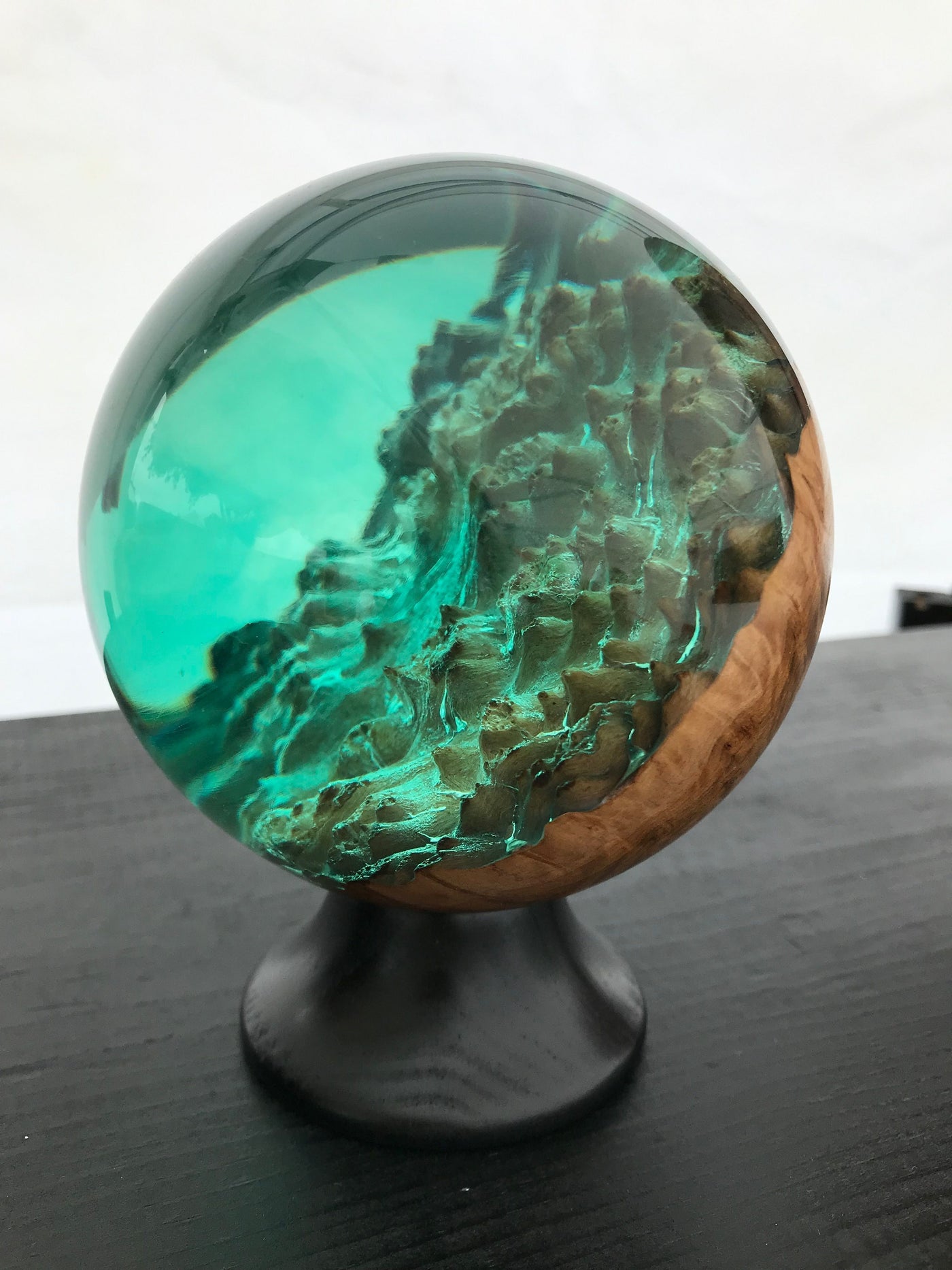 a wooden dome with clear resin art piece