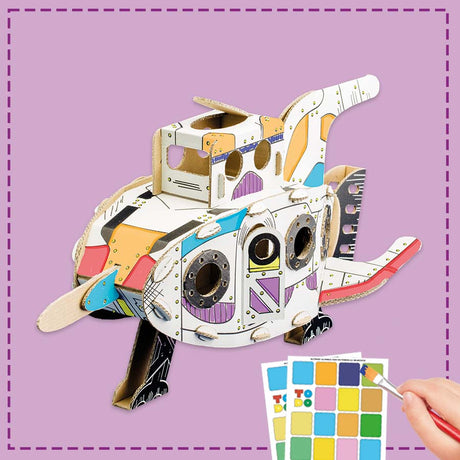 Colorful 3D cardboard space rocket with paint swatches and a brush on a purple background