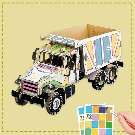 cardboard tipper truck model being painted by a child