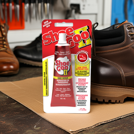 a packet of shoe goo 2 sitting on a workbench next to some repaired shoes and boots