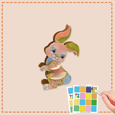 Colorful cartoon bunny cutout with color swatch and brush on beige background