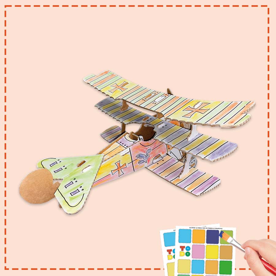 cardboard 3d model of the red barons plane being coloured in by a child