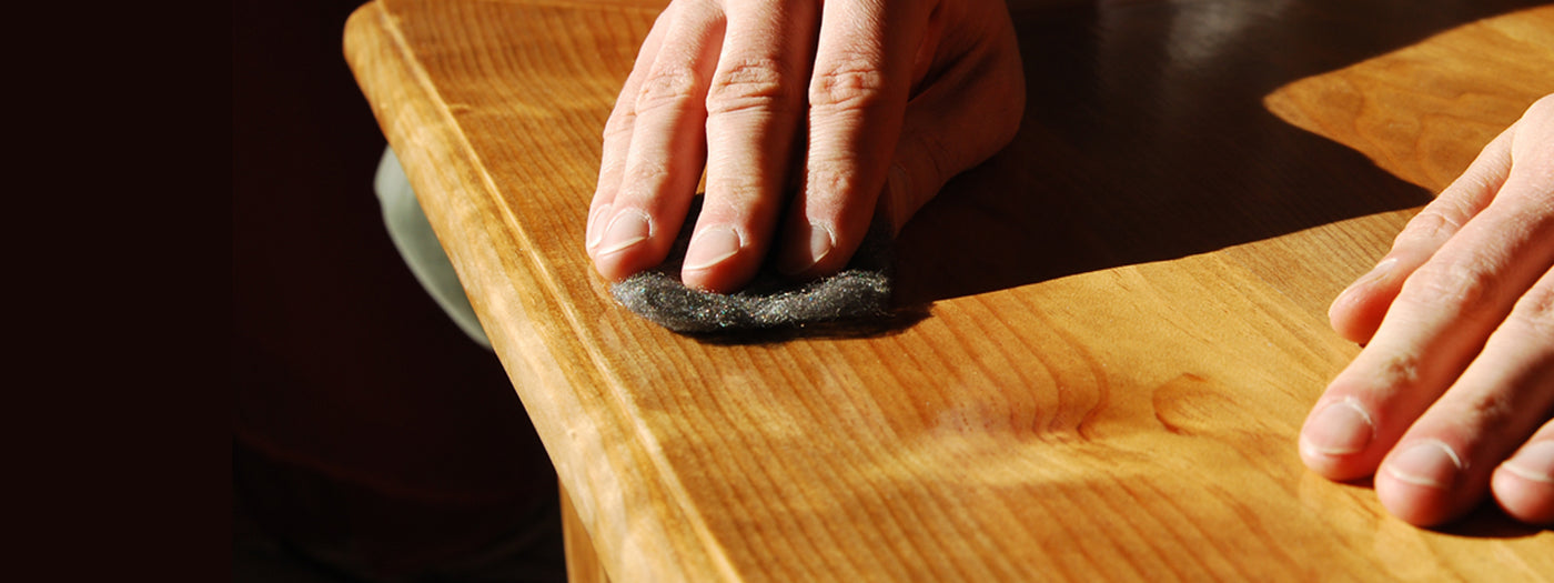 A woodworker finishing a wooden surface
